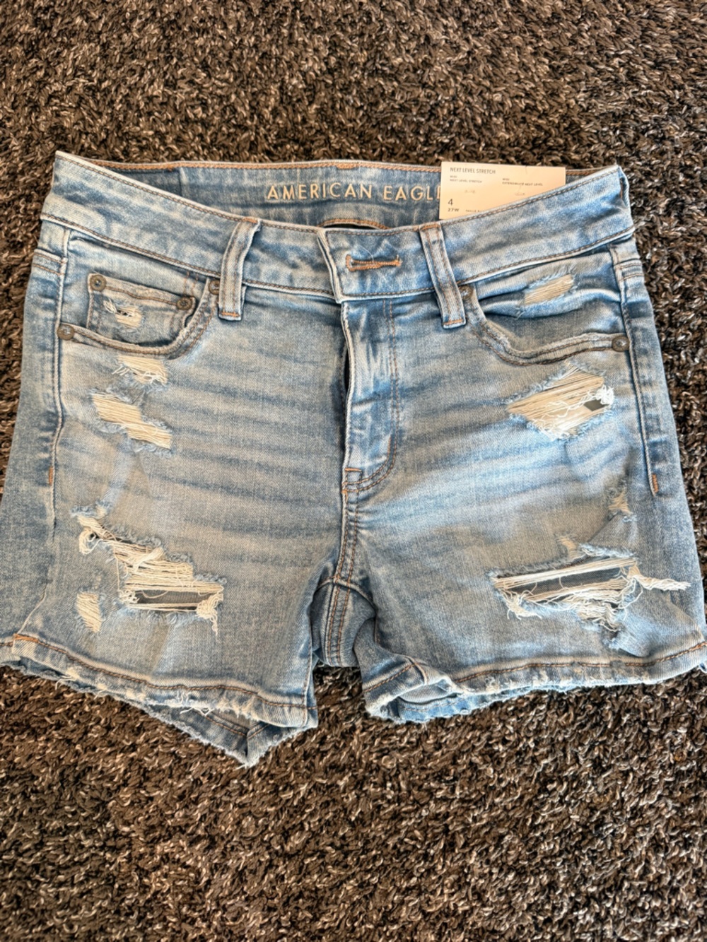American Eagle light blue denim shorts with tan stitching